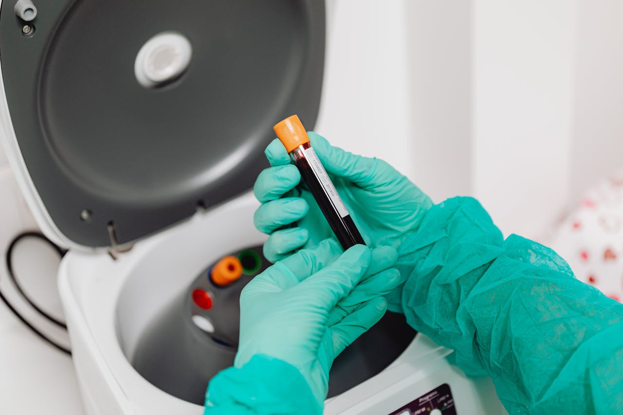 our-story Laboratory scene with a healthcare professional preparing a blood sample for analysis using a centrifuge.